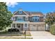 Charming two-story home featuring a three-car garage, brick accents, and a well-maintained front yard at 201 Bog Hill Ln, Cary, NC 27519