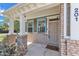 Inviting front porch featuring brick columns, white trim, and a stylish entrance door with a small porch window at 201 Bog Hill Ln, Cary, NC 27519
