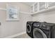 Laundry room equipped with washer and dryer and cabinets and a window at 201 Bog Hill Ln, Cary, NC 27519