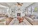 Bright living room with fireplace, built-in shelving, ceiling fan, and neutral color palette at 201 Bog Hill Ln, Cary, NC 27519