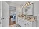 Bright main bathroom featuring double sinks, framed mirror and white cabinets, opening to the main bedroom at 201 Bog Hill Ln, Cary, NC 27519