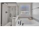 Spacious main bathroom with large soaking tub, glass-enclosed shower, and decorative window for privacy at 201 Bog Hill Ln, Cary, NC 27519