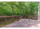View of the back deck overlooking a tranquil wooded backyard at 208 W Camden Forest Dr, Cary, NC 27518