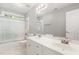 Bathroom featuring dual sinks, white cabinets, vanity mirror and a shower with glass enclosure at 208 W Camden Forest Dr, Cary, NC 27518