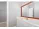 Well-lit bathroom featuring a single vanity, marble countertop and framed mirror at 208 W Camden Forest Dr, Cary, NC 27518