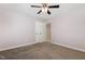 Carpeted bedroom with neutral walls and white trim, ceiling fan, and closet at 208 W Camden Forest Dr, Cary, NC 27518