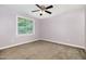 This bedroom features a ceiling fan and a window with outside views at 208 W Camden Forest Dr, Cary, NC 27518