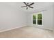 The cozy bedroom is filled with natural light, featuring a neutral palette and plush carpeting at 208 W Camden Forest Dr, Cary, NC 27518