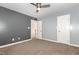 Bedroom featuring modern ceiling fan, neutral paint and carpet floors with a double door closet at 208 W Camden Forest Dr, Cary, NC 27518