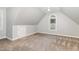 Bonus room with neutral walls, carpeting, vaulted ceilings, and arched window at 208 W Camden Forest Dr, Cary, NC 27518