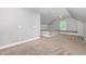 Open bonus room with carpeted platform area, natural light from the window at 208 W Camden Forest Dr, Cary, NC 27518