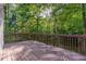 Wooden deck overlooking a lush, green backyard with mature trees at 208 W Camden Forest Dr, Cary, NC 27518