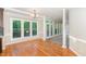 A bright and airy dining room with hardwood floors and large windows overlooking the backyard at 208 W Camden Forest Dr, Cary, NC 27518
