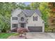 Charming two-story home with stone accents, attached two-car garage, and beautiful landscaping at 208 W Camden Forest Dr, Cary, NC 27518