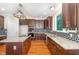 Bright kitchen boasts granite countertops, an island with a cooktop, and stainless steel appliances at 208 W Camden Forest Dr, Cary, NC 27518