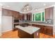 Modern kitchen featuring stainless steel appliances, dark wood cabinets, and granite countertops at 208 W Camden Forest Dr, Cary, NC 27518
