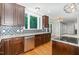 A spacious kitchen with stainless steel appliances and granite countertops, seamlessly flowing into the dining area at 208 W Camden Forest Dr, Cary, NC 27518