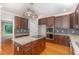 A gourmet kitchen featuring granite countertops, stainless steel appliances, and custom cabinetry at 208 W Camden Forest Dr, Cary, NC 27518