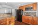 A kitchen with wooden cabinets, tiled backsplash and stainless steel appliances at 208 W Camden Forest Dr, Cary, NC 27518