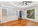 Spacious living room featuring hardwood floors, wainscoting, and double doors at 208 W Camden Forest Dr, Cary, NC 27518