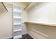 Walk-in closet with built-in shelving and wooden hanging rods offering ample storage space at 208 W Camden Forest Dr, Cary, NC 27518