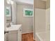 Bathroom with updated fixtures, vanity, wood look floor, and natural light at 2108 Laurel Mill Centerville Rd, Louisburg, NC 27549