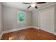 Bedroom featuring hardwood floors, bright windows, ceiling fan and a closet at 2108 Laurel Mill Centerville Rd, Louisburg, NC 27549