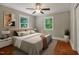 Bedroom featuring two windows, natural lighting, ceiling fan, and a bed with nightstands at 2108 Laurel Mill Centerville Rd, Louisburg, NC 27549
