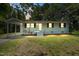 Charming single-story home with a light-colored facade, a covered carport, and fresh landscaping at 2108 Laurel Mill Centerville Rd, Louisburg, NC 27549