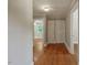 Hallway with natural wood floors and white doors and trim at 2108 Laurel Mill Centerville Rd, Louisburg, NC 27549