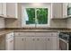 Bright kitchen with white cabinets, stainless steel appliances, and natural light at 2108 Laurel Mill Centerville Rd, Louisburg, NC 27549