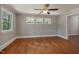 Spacious living room featuring three windows and gleaming hardwood floors at 2108 Laurel Mill Centerville Rd, Louisburg, NC 27549
