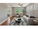 Bright living room with big windows, a chevron rug, and white modern furniture at 2108 Laurel Mill Centerville Rd, Louisburg, NC 27549