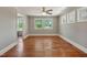 Living room with three windows for natural light and gleaming hardwood floors at 2108 Laurel Mill Centerville Rd, Louisburg, NC 27549