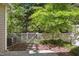 Patio with privacy fence surrounded by lush landscaping and mature trees at 2207 Bankshill Row, Raleigh, NC 27614