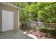 Patio with privacy fence surrounded by lush landscaping and mature trees at 2207 Bankshill Row, Raleigh, NC 27614