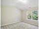 Cozy bedroom with carpet, a window with natural light, and neutral walls at 2207 Bankshill Row, Raleigh, NC 27614