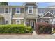 Inviting townhome with stone accents, manicured landscaping, and a cozy front porch at 2207 Bankshill Row, Raleigh, NC 27614