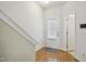 Bright foyer featuring hardwood floors, a white door, and access to other rooms at 2207 Bankshill Row, Raleigh, NC 27614