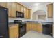 Functional kitchen with black appliances, ample cabinet space, and a view of the living room at 2207 Bankshill Row, Raleigh, NC 27614