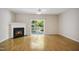 Bright living room featuring a fireplace, sliding door, and wood-look floors at 2207 Bankshill Row, Raleigh, NC 27614
