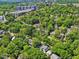 An aerial view displays a property surrounded by vibrant green trees and well-maintained neighborhood streets at 224 E Park Dr, Raleigh, NC 27605