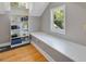 Close up on attic built-in storage with shelving and a window with green natural light at 224 E Park Dr, Raleigh, NC 27605