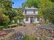 Backyard featuring an outdoor brick patio, well-manicured garden, and white facade at 224 E Park Dr, Raleigh, NC 27605