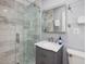 Modern bathroom featuring a glass-enclosed shower with stylish tile work and a vanity with a marble countertop at 224 E Park Dr, Raleigh, NC 27605
