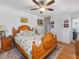 Cozy bedroom featuring a ceiling fan, hardwood floors, and a floral patterned bedspread at 224 E Park Dr, Raleigh, NC 27605