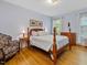 Bedroom features wood floors, a four poster bed and large windows at 224 E Park Dr, Raleigh, NC 27605