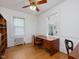 Bedroom with hardwood floors, radiator, and a large window for natural light at 224 E Park Dr, Raleigh, NC 27605