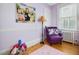 Bedroom features a purple chair and wood floors at 224 E Park Dr, Raleigh, NC 27605