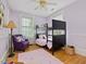 bedroom features a bunk bed, hardwood floors, a plush chair, and plenty of natural light at 224 E Park Dr, Raleigh, NC 27605